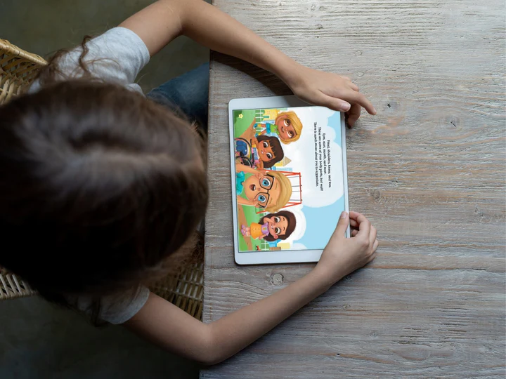 A young girl reading the digital Every Body Talk book on a tablet